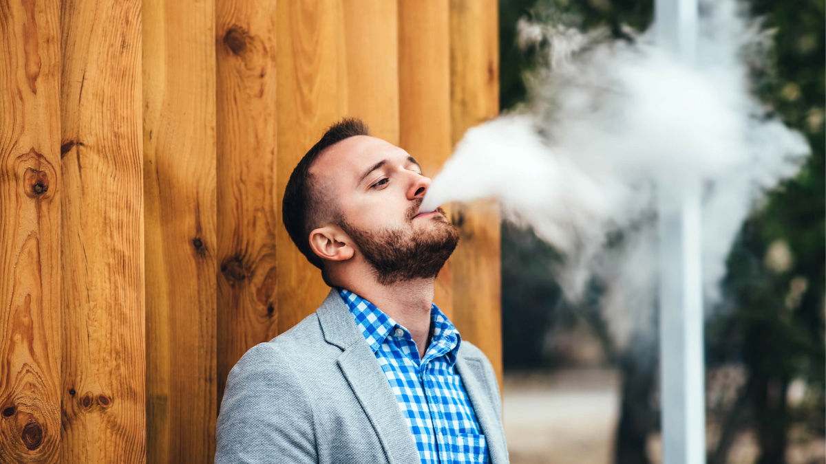 A man in a checkered jacket outside vaping THCa near Towaco, New Jersey.